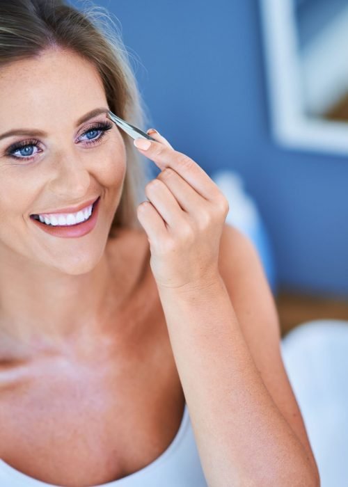 beautiful-woman-with-tweezers-in-the-bathroom-2022-05-19-05-10-20-utc-min